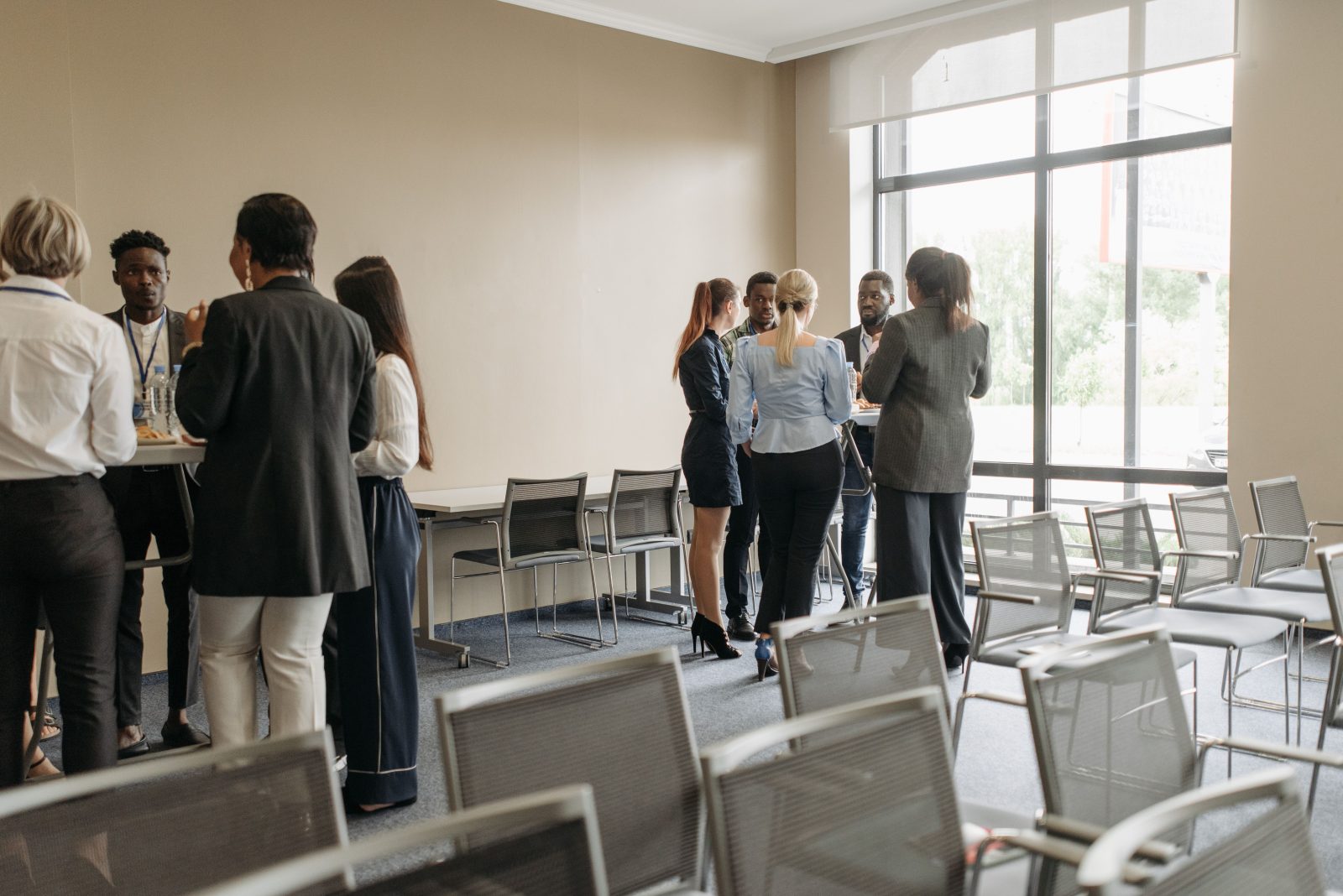 A group of people talking together in a bright training room